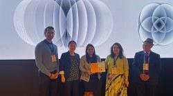 Dr. Wang with Rahul Thakkar holding the Best Paper Certificate with conference delegates